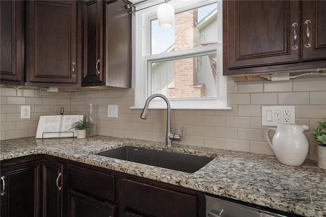 7243 Rene St, Shawnee, KS 66216 - kitchen with a sink, dark brown cabinetry, and decorative backsplash