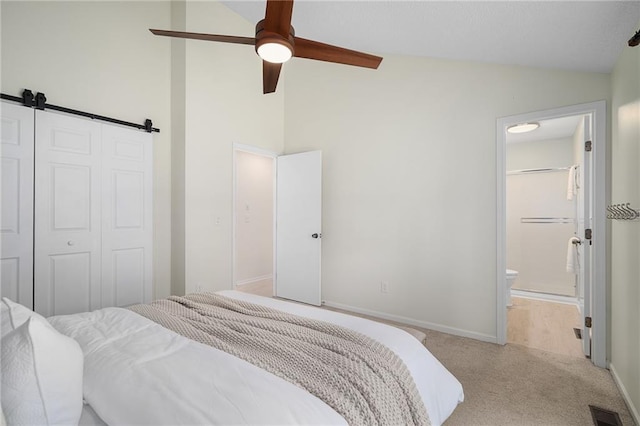 7243 Rene St, Shawnee, KS 66216 - bedroom with vaulted ceiling, light carpet, a closet, a barn door, and baseboards