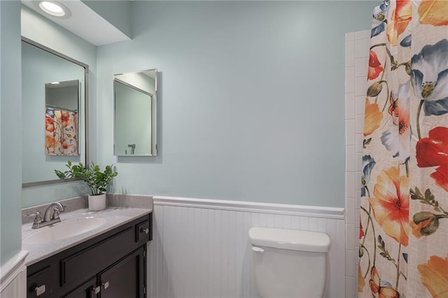 7243 Rene St, Shawnee, KS 66216 - bathroom featuring wainscoting, vanity, toilet, and a shower with curtain