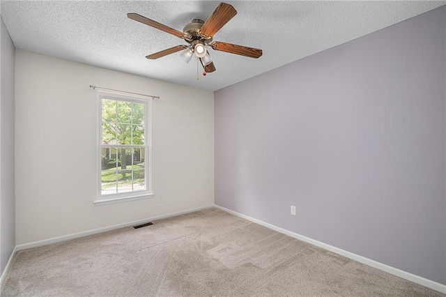7243 Rene St, Shawnee, KS 66216 - carpeted spare room featuring a ceiling fan, baseboards, and a textured ceiling