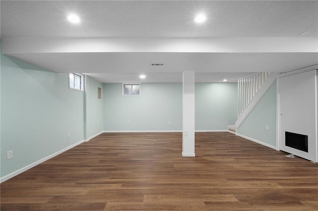 7243 Rene St, Shawnee, KS 66216 - finished basement with recessed lighting, wood finished floors, baseboards, and stairs