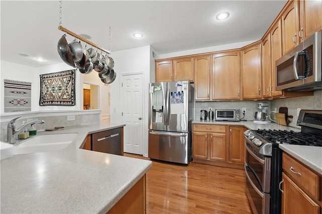 22480 W 113th St, Olathe, KS 66061 - kitchen featuring appliances with stainless steel finishes, a sink, light countertops, tasteful backsplash, and recessed lighting