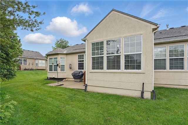 22480 W 113th St, Olathe, KS 66061 - rear view of house with a patio, a yard, and stucco siding