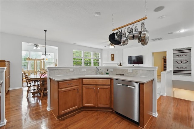 22480 W 113th St, Olathe, KS 66061 - kitchen with stainless steel dishwasher, ceiling fan, a sink, brown cabinets, and light countertops
