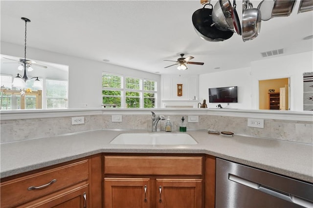 22480 W 113th St, Olathe, KS 66061 - kitchen featuring dishwasher, a sink, ceiling fan, brown cabinets, and light countertops