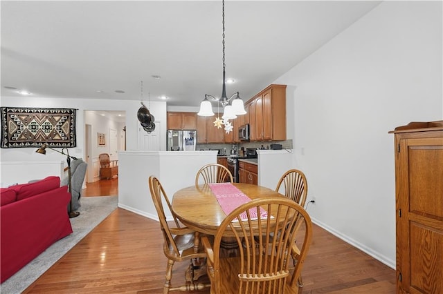 22480 W 113th St, Olathe, KS 66061 - dining area featuring a chandelier, light wood-type flooring, recessed lighting, and baseboards