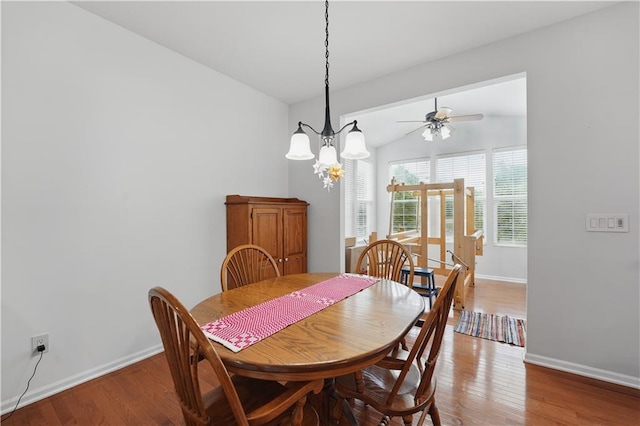22480 W 113th St, Olathe, KS 66061 - dining space with vaulted ceiling, baseboards, wood finished floors, a chandelier, and ceiling fan
