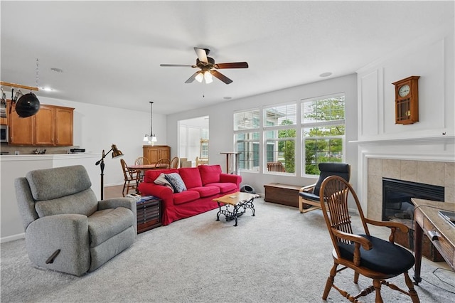 22480 W 113th St, Olathe, KS 66061 - carpeted living room with a ceiling fan and a tile fireplace