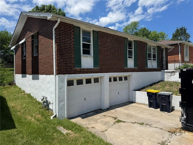 8724 N Jefferson St, Kansas City, MO 64155 - view of side of home with brick siding, concrete driveway, and a garage