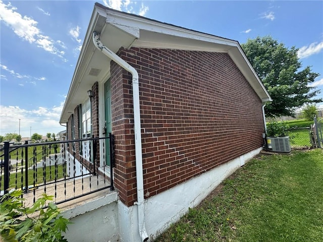 8724 N Jefferson St, Kansas City, MO 64155 - view of property exterior featuring brick siding and central AC
