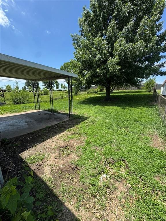 8724 N Jefferson St, Kansas City, MO 64155 - view of green lawn featuring a carport and a patio