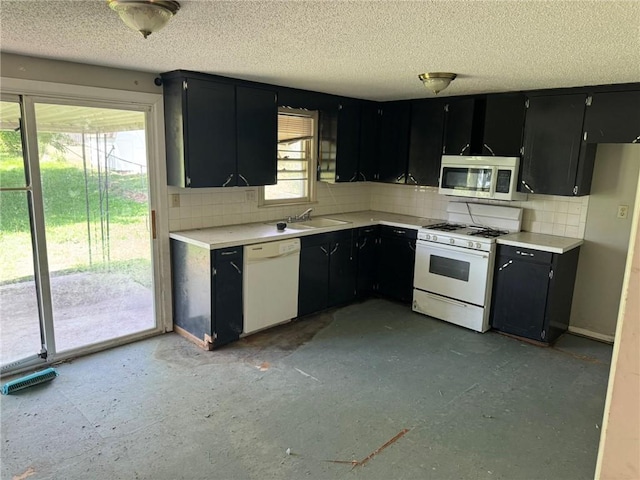 8724 N Jefferson St, Kansas City, MO 64155 - kitchen with white appliances, dark cabinets, a sink, and a textured ceiling