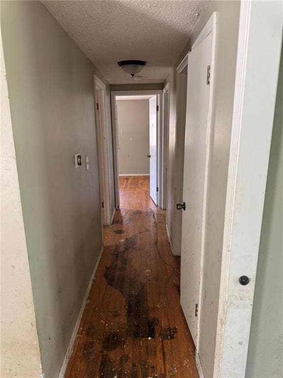 8724 N Jefferson St, Kansas City, MO 64155 - hall featuring wood-type flooring, a textured ceiling, and baseboards