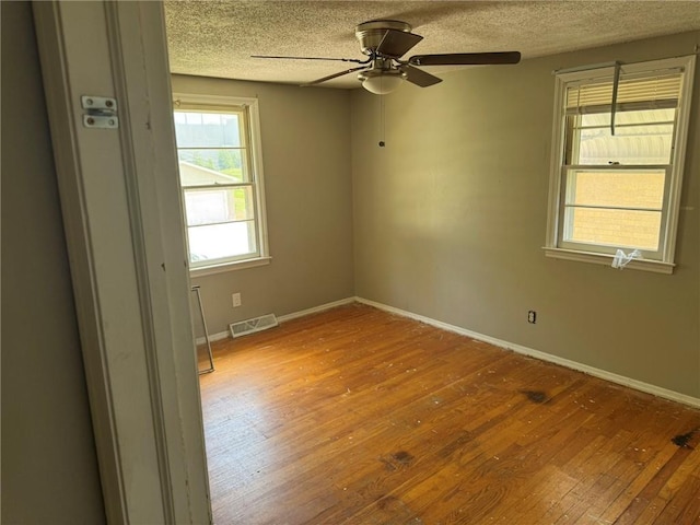 8724 N Jefferson St, Kansas City, MO 64155 - spare room featuring hardwood / wood-style floors, a textured ceiling, ceiling fan, and baseboards