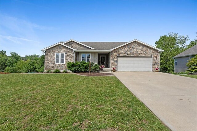 3208 Arbor Lake Dr, Saint Joseph, MO 64506 - ranch-style home with stone siding, an attached garage, driveway, and a front yard