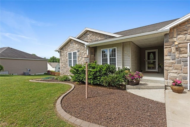 3208 Arbor Lake Dr, Saint Joseph, MO 64506 - doorway to property with stone siding, a lawn, and cooling unit