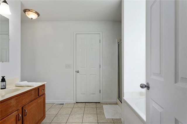 3208 Arbor Lake Dr, Saint Joseph, MO 64506 - bathroom with vanity, tile patterned flooring, a stall shower, and a garden tub