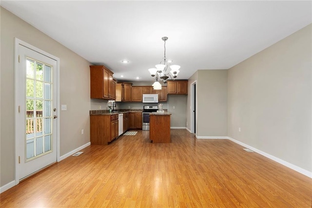 3208 Arbor Lake Dr, Saint Joseph, MO 64506 - kitchen featuring white appliances, a chandelier, baseboards, light wood finished floors, and recessed lighting