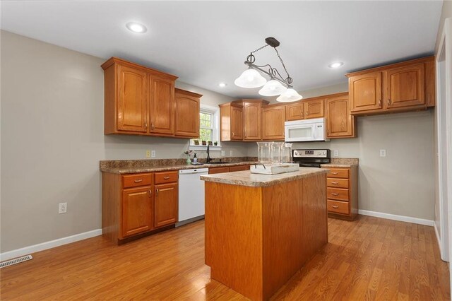 3208 Arbor Lake Dr, Saint Joseph, MO 64506 - kitchen featuring white appliances, brown cabinets, a sink, and recessed lighting