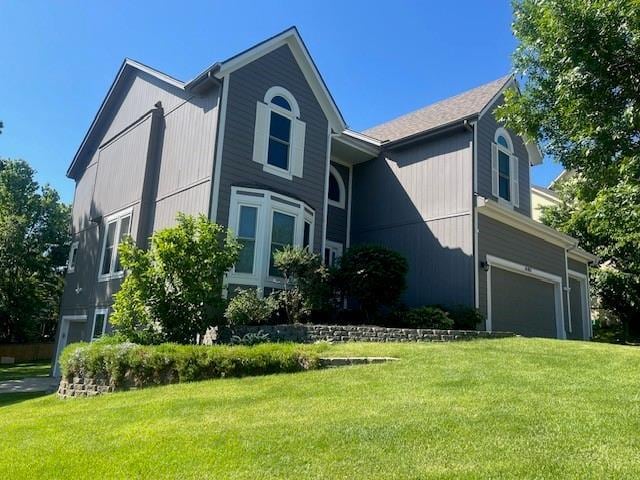 14801 W 70th St, Shawnee, KS 66216 - view of front of home with a front yard and a garage