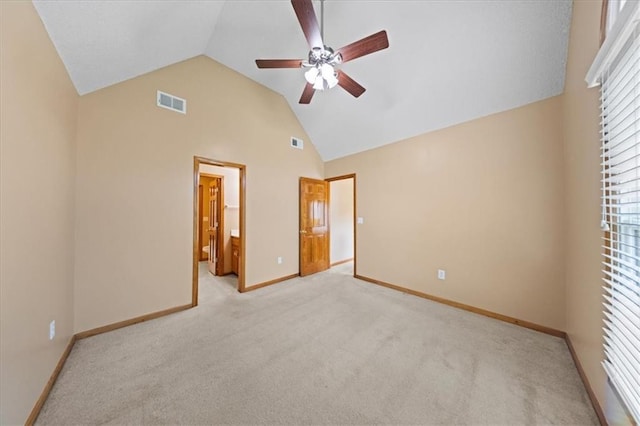 14801 W 70th St, Shawnee, KS 66216 - unfurnished bedroom featuring light carpet, baseboards, high vaulted ceiling, ceiling fan, and connected bathroom