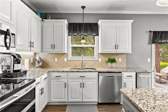 9820 N Donnelly Ave, Kansas City, MO 64157 - kitchen with appliances with stainless steel finishes, a sink, dark wood finished floors, white cabinets, and crown molding