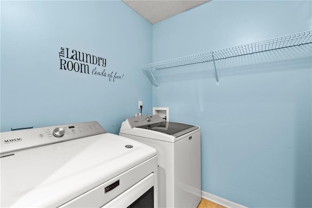 9820 N Donnelly Ave, Kansas City, MO 64157 - laundry area featuring washer and clothes dryer and baseboards