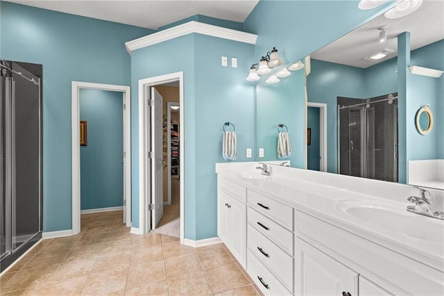 9820 N Donnelly Ave, Kansas City, MO 64157 - bathroom featuring a stall shower, double vanity, a walk in closet, tile patterned floors, and baseboards