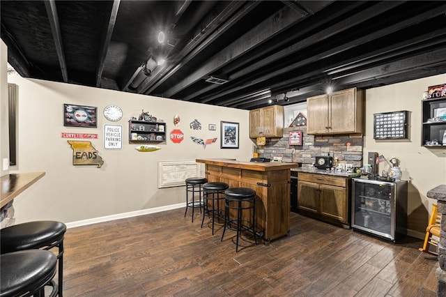 9820 N Donnelly Ave, Kansas City, MO 64157 - indoor dry bar featuring beverage cooler, dark wood-type flooring, baseboards, and rail lighting