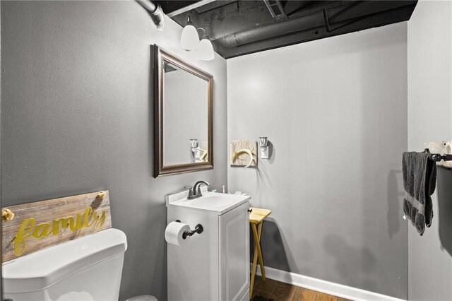 9820 N Donnelly Ave, Kansas City, MO 64157 - half bath with toilet, wood finished floors, and vanity