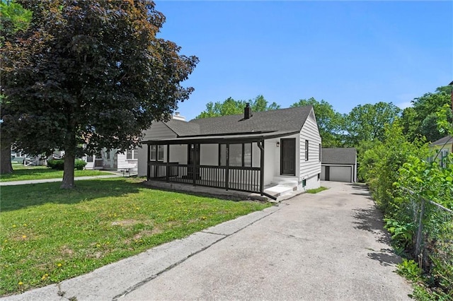 2317 S Maywood Ave, Independence, MO 64052 - view of front of home featuring a front yard, a garage, an outbuilding, and a shingled roof