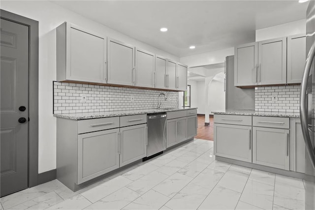 2317 S Maywood Ave, Independence, MO 64052 - kitchen with appliances with stainless steel finishes, light marble finish floors, gray cabinets, recessed lighting, and backsplash
