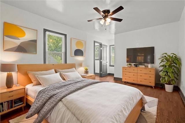 2317 S Maywood Ave, Independence, MO 64052 - bedroom featuring wood finished floors, baseboards, and a ceiling fan