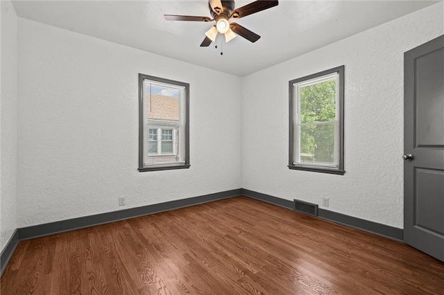 2317 S Maywood Ave, Independence, MO 64052 - spare room with wood finished floors, baseboards, ceiling fan, and a textured wall