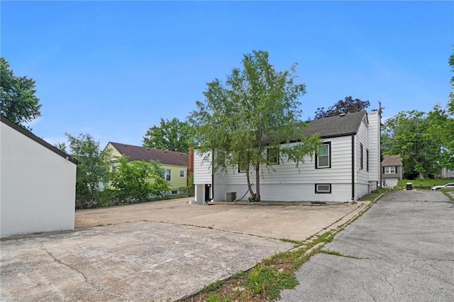 2317 S Maywood Ave, Independence, MO 64052 - rear view of property with a chimney and central AC unit
