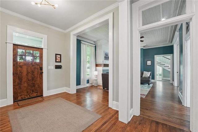 906 E Piankishaw St, Paola, KS 66071 - foyer with crown molding, stairway, wood finished floors, baseboards, and a chandelier