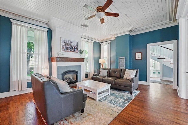906 E Piankishaw St, Paola, KS 66071 - living room with a tile fireplace, ceiling fan, ornamental molding, baseboards, and stairs