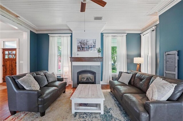 906 E Piankishaw St, Paola, KS 66071 - living room featuring ceiling fan, plenty of natural light, wood finished floors, a fireplace, and crown molding