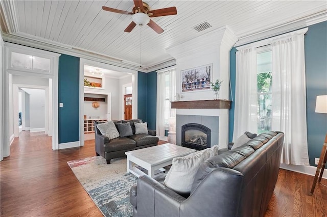 906 E Piankishaw St, Paola, KS 66071 - living room featuring a ceiling fan, ornamental molding, a fireplace, baseboards, and dark wood-style flooring