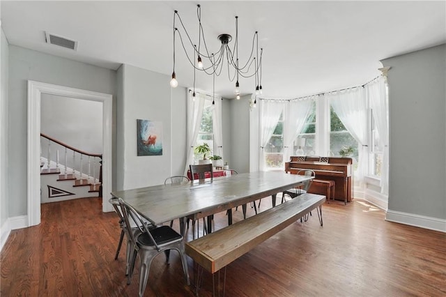 906 E Piankishaw St, Paola, KS 66071 - dining space featuring stairway, wood finished floors, baseboards, and a chandelier