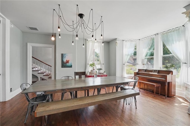 906 E Piankishaw St, Paola, KS 66071 - dining room featuring wood finished floors, stairway, and baseboards
