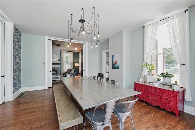 906 E Piankishaw St, Paola, KS 66071 - dining room with dark wood-style flooring and baseboards