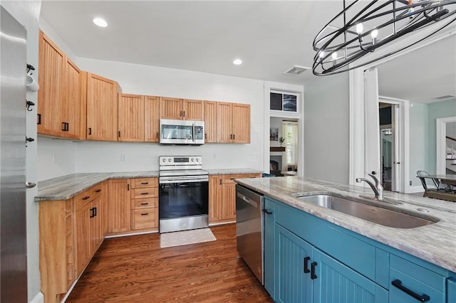 906 E Piankishaw St, Paola, KS 66071 - kitchen with appliances with stainless steel finishes, a sink, dark wood finished floors, recessed lighting, and pendant lighting