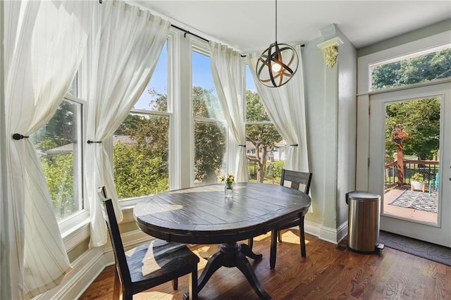 906 E Piankishaw St, Paola, KS 66071 - dining room with plenty of natural light, dark wood finished floors, and baseboards