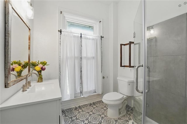 906 E Piankishaw St, Paola, KS 66071 - full bathroom featuring vanity, toilet, a stall shower, and tile patterned flooring