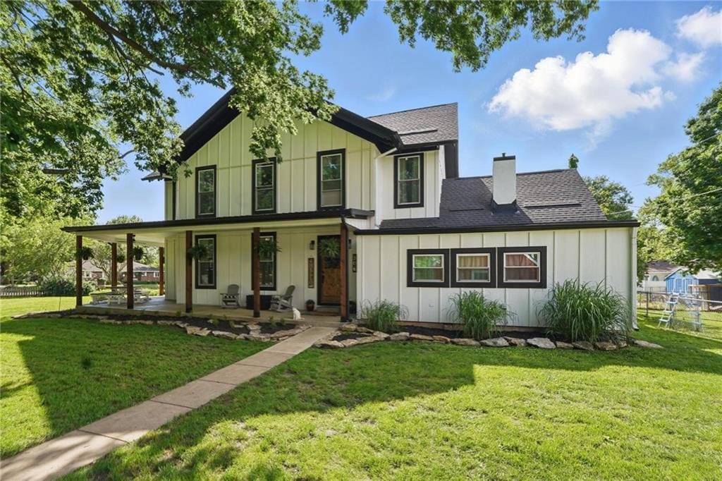 906 E Piankishaw St, Paola, KS 66071 - modern farmhouse style home with board and batten siding, a chimney, and covered porch