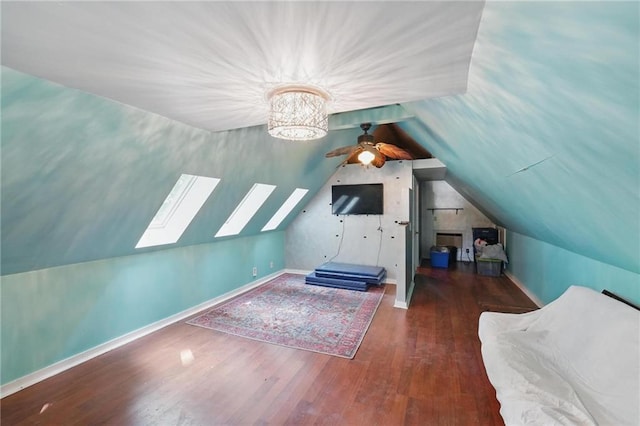 906 E Piankishaw St, Paola, KS 66071 - bonus room featuring lofted ceiling, wood finished floors, a skylight, a ceiling fan, and baseboards