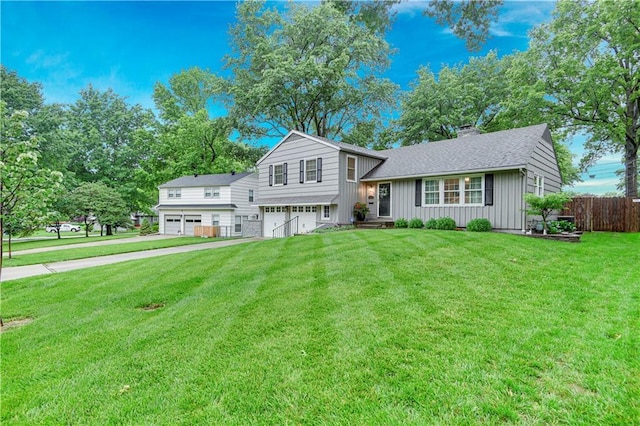 6016 W 85th St, Overland Park, KS 66207 - split level home featuring an attached garage, board and batten siding, and a chimney