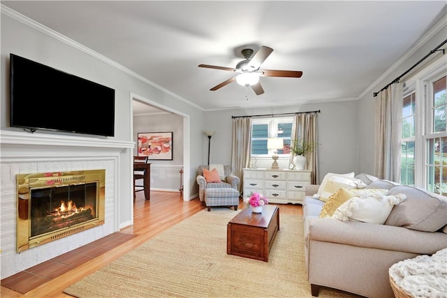 6016 W 85th St, Overland Park, KS 66207 - living room featuring wood finished floors, crown molding, ceiling fan, and a tiled fireplace