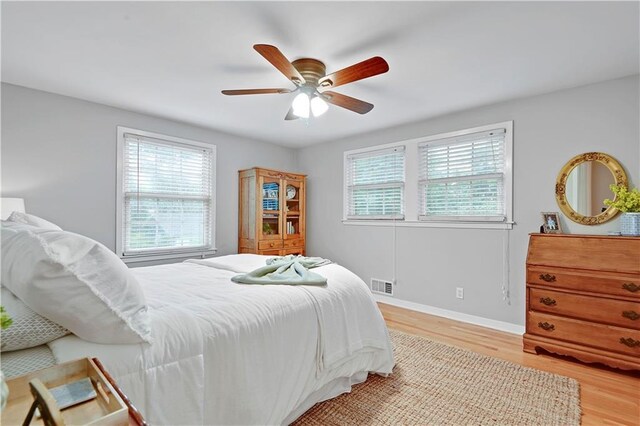 6016 W 85th St, Overland Park, KS 66207 - bedroom with multiple windows, light wood-style flooring, baseboards, and a ceiling fan